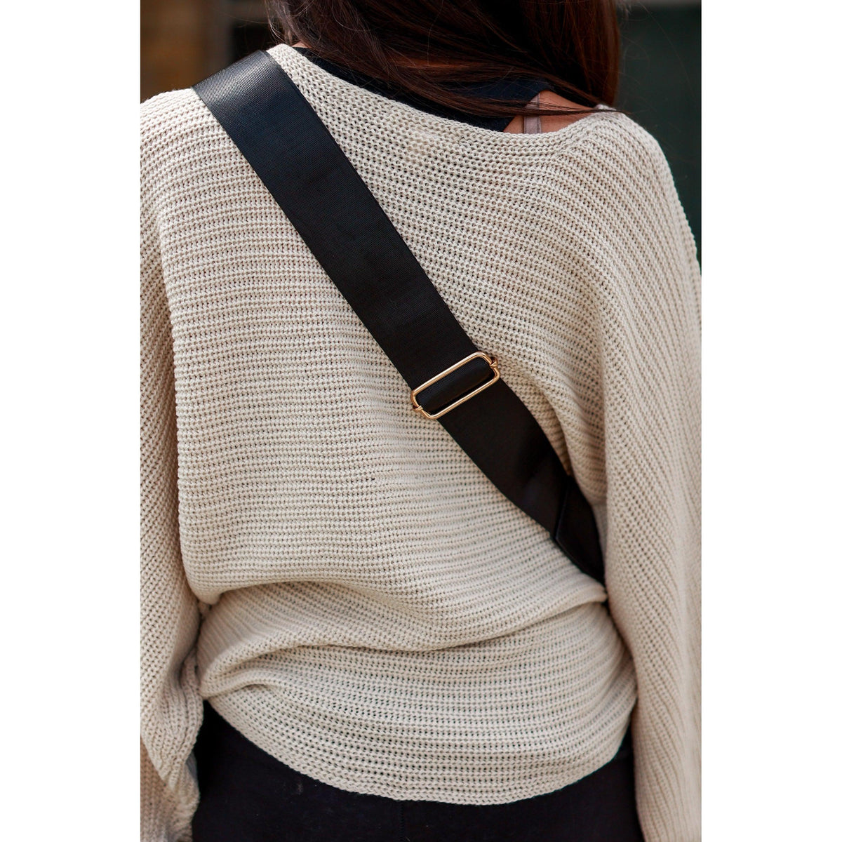 Women's sling bag with zipper closure and adjustable strap