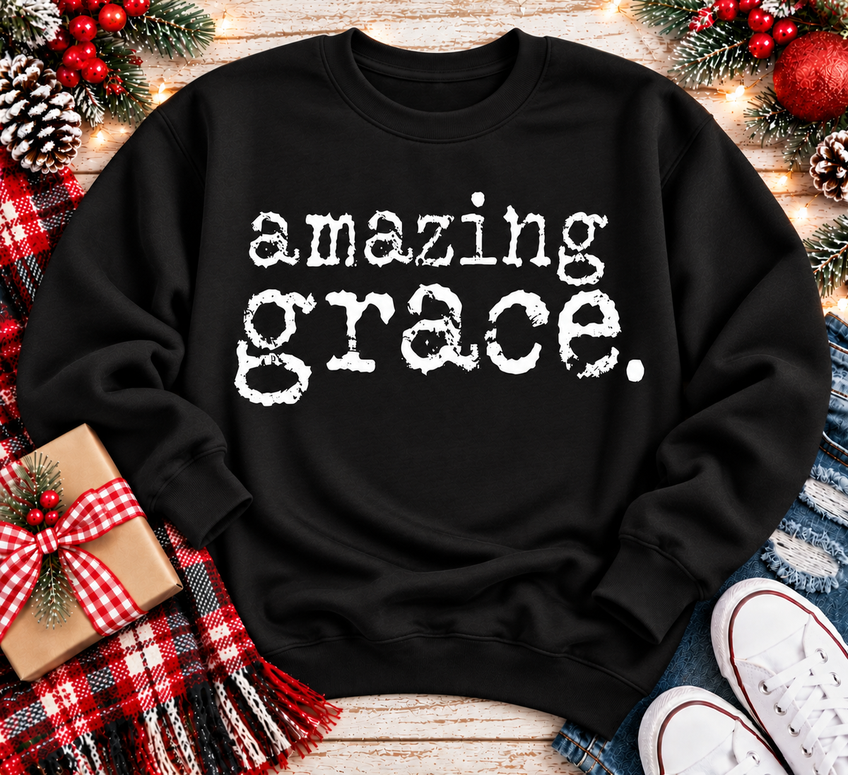 A black crewneck sweatshirt with the words 'amazing grace.' printed in a distressed white typewriter font across the chest.