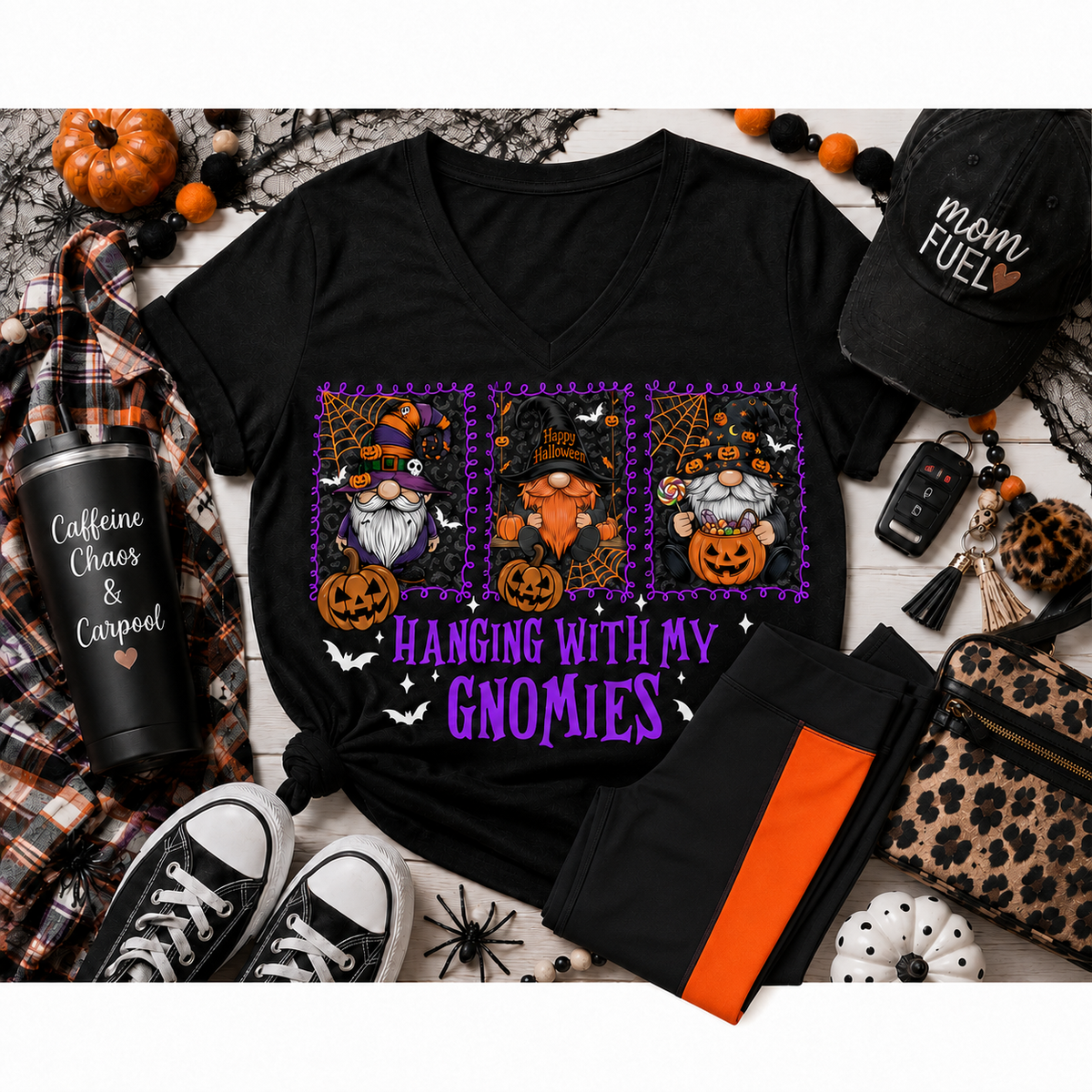 Black Hanging With My Gnomies Halloween V-neck T-shirt displayed in a festive flat lay with black-and-orange panel leggings, pumpkins and Halloween accessories