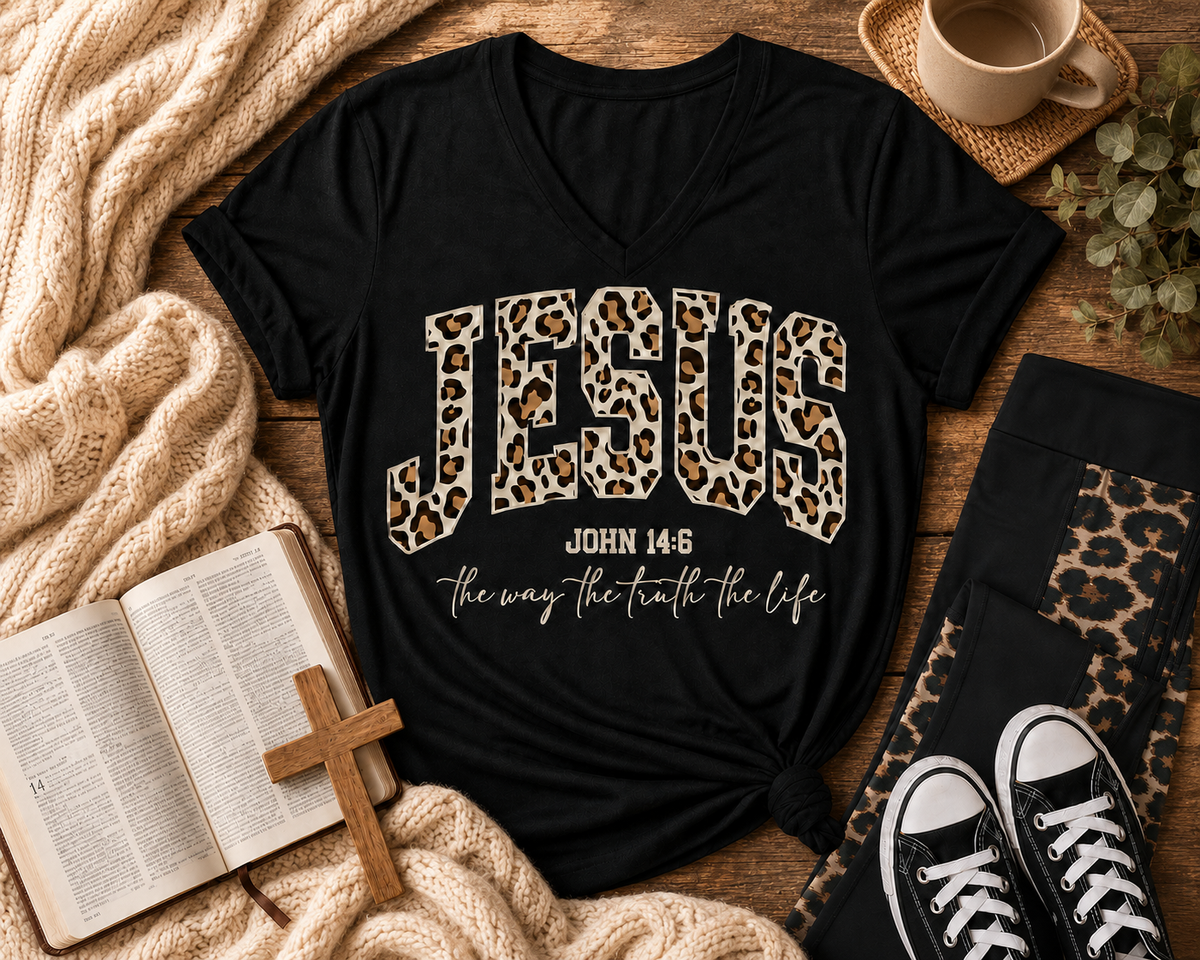 Black Jesus leopard-print John 14:6 V-neck T-shirt displayed with leopard-panel leggings, an open Bible and wooden cross in a cozy neutral flat lay