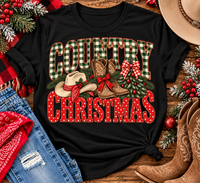Country Christmas graphic tee with green plaid lettering, red polka dots, cowboy boots, western hat and festive Christmas bows.
