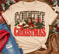 Country Christmas graphic tee with green plaid lettering, red polka dots, cowboy boots, western hat and festive Christmas bows.