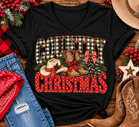 Country Christmas graphic tee with green plaid lettering, red polka dots, cowboy boots, western hat and festive Christmas bows.