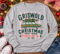 Christmas graphic tee featuring Griswold Christmas Tree Farm vintage green station wagon with Christmas tree and retro lettering.