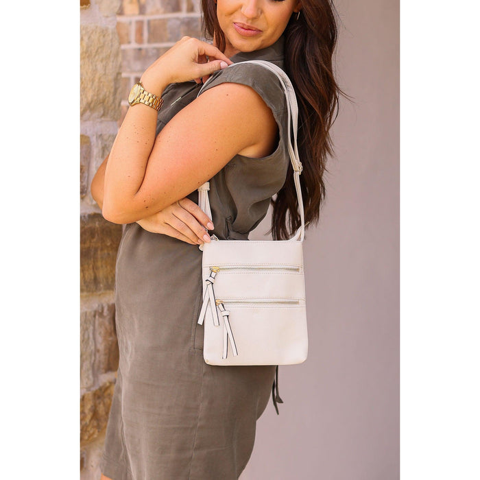 Envelope style crossbody bag with multiple zipper compartments