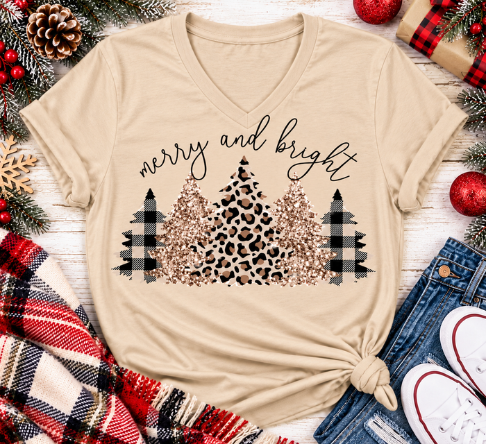 Merry and Bright Christmas graphic apparel featuring leopard print, buffalo plaid and glitter-inspired gold Christmas trees, available in three colors and four styles including crewneck tee, V-neck tee, sweatshirt and hoodie.