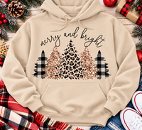 Merry and Bright Christmas graphic apparel featuring leopard print, buffalo plaid and glitter-inspired gold Christmas trees, available in three colors and four styles including crewneck tee, V-neck tee, sweatshirt and hoodie.