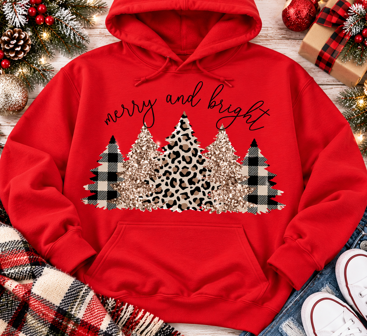 Merry and Bright Christmas graphic apparel featuring leopard print, buffalo plaid and glitter-inspired gold Christmas trees, available in three colors and four styles including crewneck tee, V-neck tee, sweatshirt and hoodie.