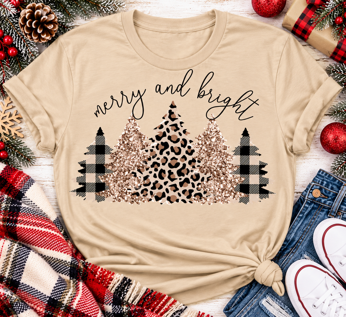 Merry and Bright Christmas graphic apparel featuring leopard print, buffalo plaid and glitter-inspired gold Christmas trees, available in three colors and four styles including crewneck tee, V-neck tee, sweatshirt and hoodie.