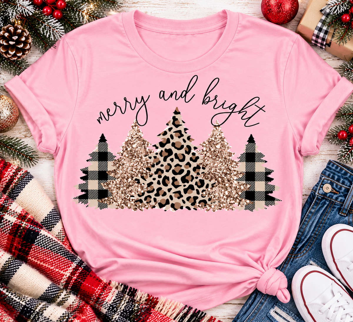 Merry and Bright Christmas graphic apparel featuring leopard print, buffalo plaid and glitter-inspired gold Christmas trees, available in three colors and four styles including crewneck tee, V-neck tee, sweatshirt and hoodie.