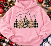 Merry and Bright Christmas graphic apparel featuring leopard print, buffalo plaid and glitter-inspired gold Christmas trees, available in three colors and four styles including crewneck tee, V-neck tee, sweatshirt and hoodie.