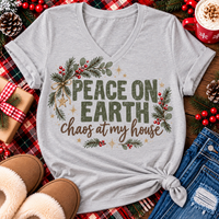 Peace on Earth Chaos at My House funny Christmas graphic apparel featuring distressed olive green lettering, rustic pine greenery, red berries and gold stars, available in sand and sport grey in short sleeve crewneck tees, V-neck tees, sweatshirts and hoodies.