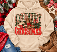 Country Christmas graphic tee with green plaid lettering, red polka dots, cowboy boots, western hat and festive Christmas bows.