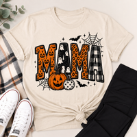 Cream Halloween Mama graphic tee featuring orange jack-o'-lantern print, ghosts, leopard print, black and white plaid, pumpkins, bats and spiderwebs.