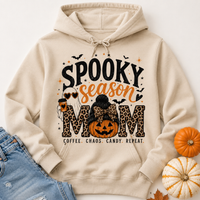 Cream Spooky Season Mom hoodie featuring leopard print lettering, coffee ghost, jack-o'-lantern pumpkin, bats and Coffee Chaos Candy Repeat text.