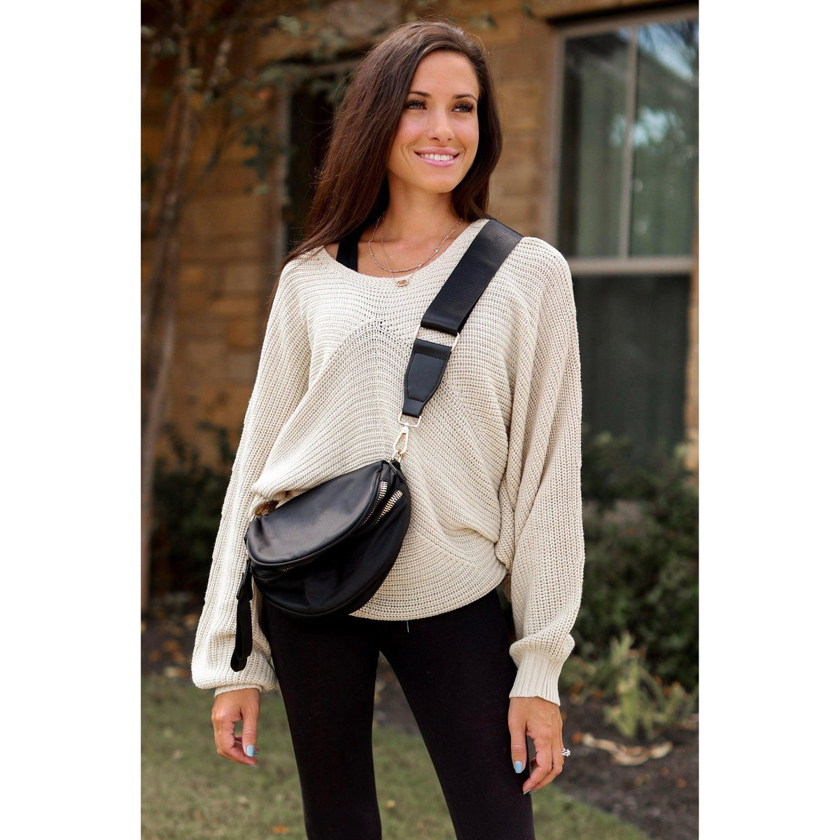 Women's sling bag with zipper closure and adjustable strap